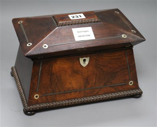 A William IV rosewood sarcophagus shaped tea caddy, with gadrooned borders inlaid with mother of pearl roundels width 25cm